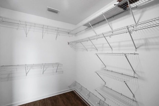 spacious closet featuring wood finished floors and visible vents