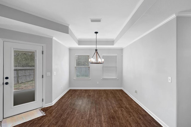 unfurnished dining area featuring ornamental molding, dark wood-style flooring, a raised ceiling, and baseboards