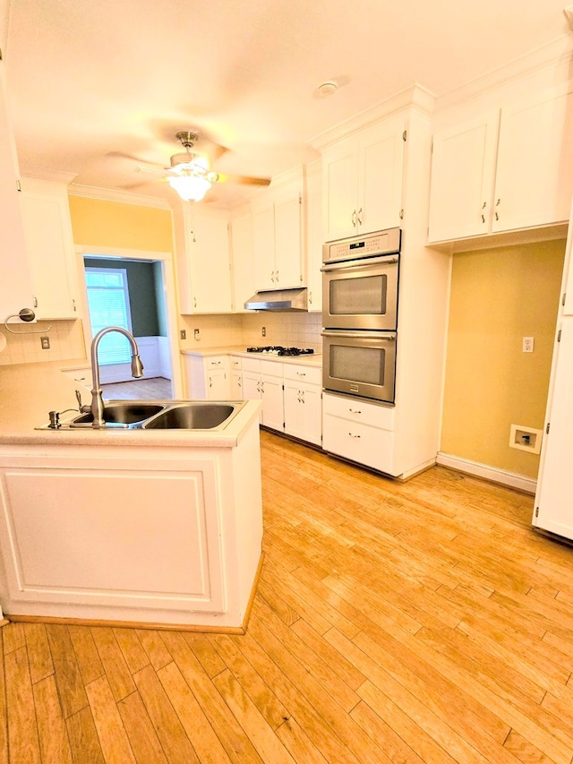2230 W County Road 16, Headland, AL 36345 - kitchen with a sink, white gas stovetop, white cabinetry, and under cabinet range hood