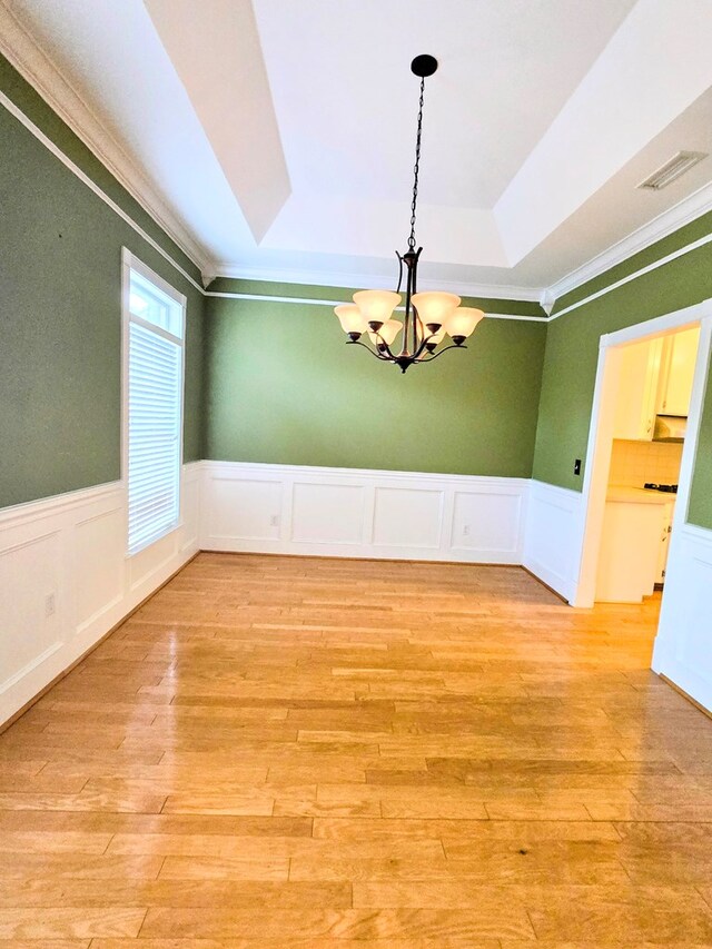 2230 W County Road 16, Headland, AL 36345 - unfurnished dining area with ornamental molding, a decorative wall, a chandelier, and light wood-type flooring
