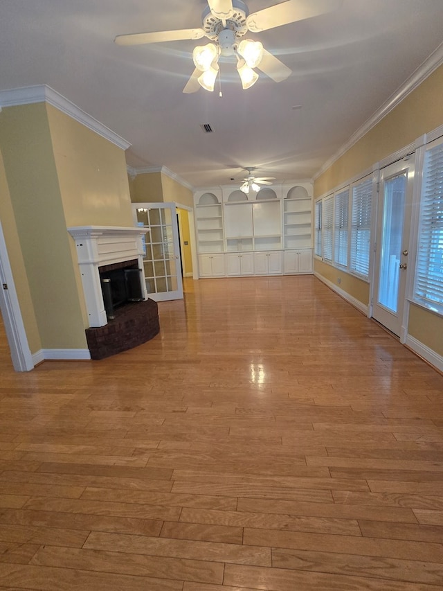 2230 W County Road 16, Headland, AL 36345 - unfurnished living room featuring wood finished floors, ceiling fan, baseboards, and a brick fireplace