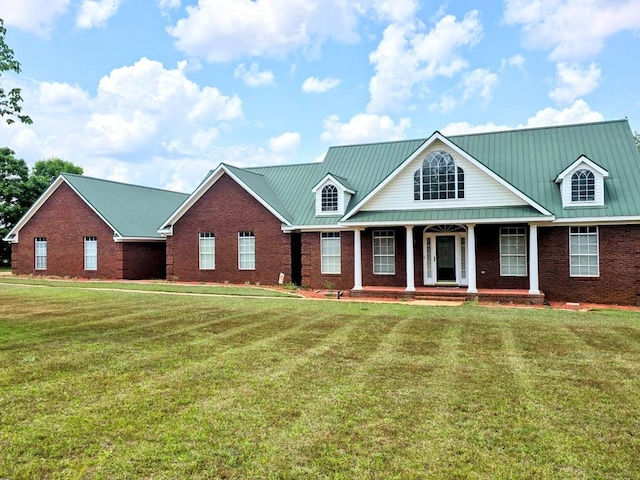 2230 W County Road 16, Headland, AL 36345 - view of front of property with covered porch, brick siding, a front lawn, and metal roof