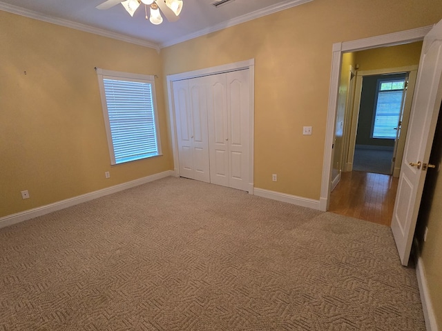 2230 W County Road 16, Headland, AL 36345 - unfurnished bedroom with a closet, baseboards, ornamental molding, light carpet, and a ceiling fan