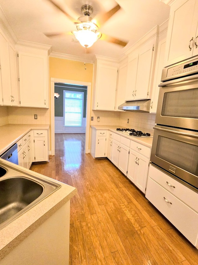2230 W County Road 16, Headland, AL 36345 - kitchen featuring stainless steel double oven, white gas stovetop, a ceiling fan, and white cabinets