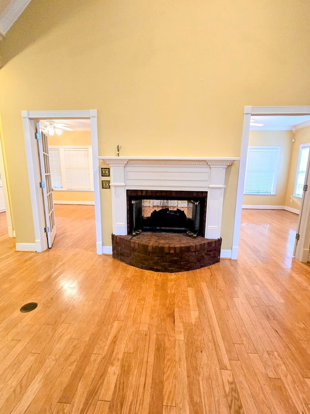 2230 W County Road 16, Headland, AL 36345 - unfurnished living room with baseboards, light wood-style floors, lofted ceiling, and a fireplace