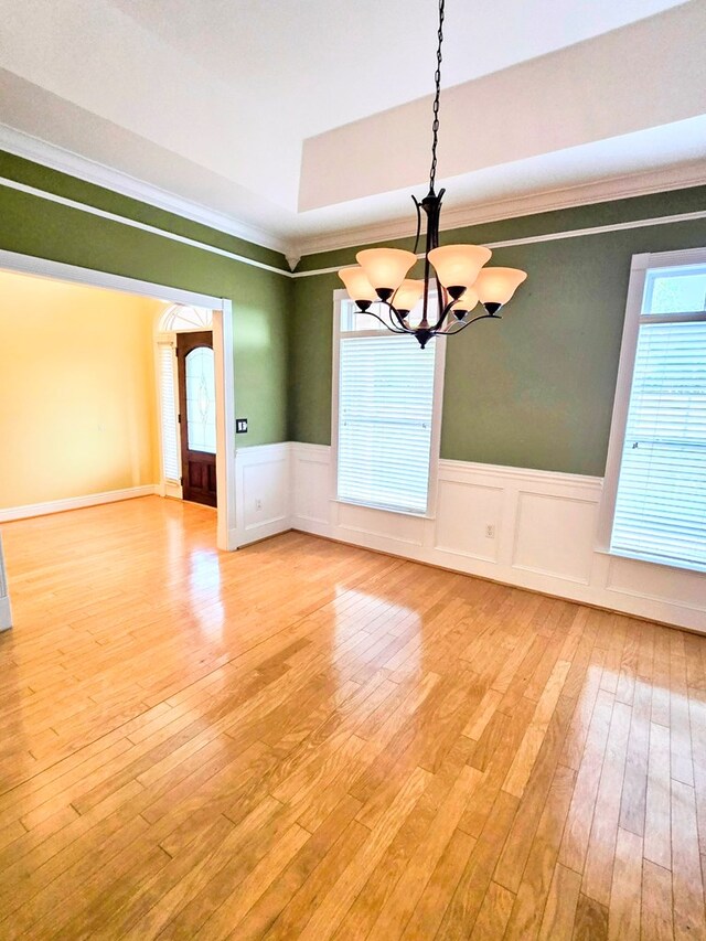 2230 W County Road 16, Headland, AL 36345 - unfurnished dining area featuring light wood-type flooring, crown molding, a notable chandelier, and wainscoting