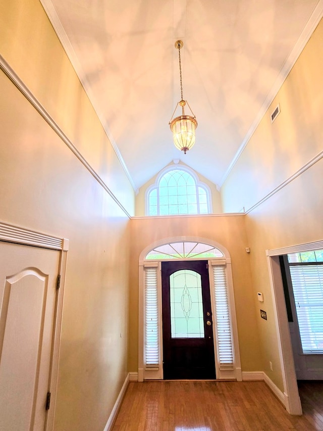 2230 W County Road 16, Headland, AL 36345 - foyer with lofted ceiling, an inviting chandelier, baseboards, and wood-type flooring