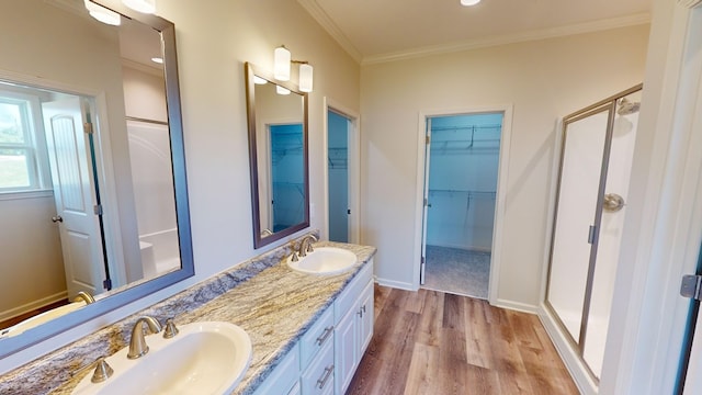 bathroom with crown molding, hardwood / wood-style floors, vanity, and an enclosed shower