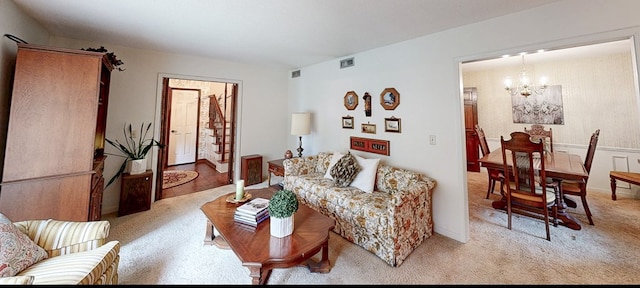 living area with a chandelier and light carpet