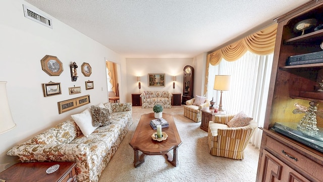 living room featuring light colored carpet and a textured ceiling