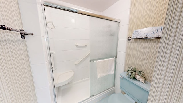 full bathroom featuring toilet and a stall shower