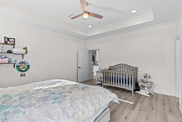 213 Archer Trl, Enterprise, AL 36351 - bedroom featuring crown molding, a tray ceiling, recessed lighting, and wood finished floors