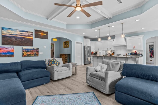 213 Archer Trl, Enterprise, AL 36351 - living room featuring beamed ceiling, arched walkways, a ceiling fan, and light wood-type flooring