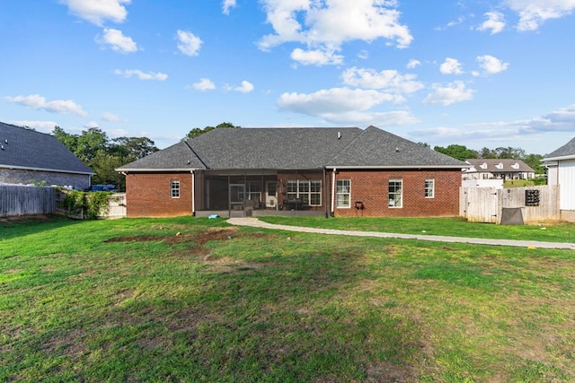 213 Archer Trl, Enterprise, AL 36351 - back of property with a sunroom, a lawn, fence, and brick siding