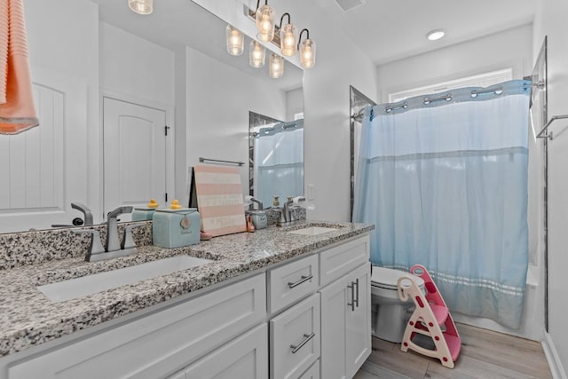 213 Archer Trl, Enterprise, AL 36351 - full bath featuring a sink, toilet, wood finished floors, and shower / tub combo with curtain