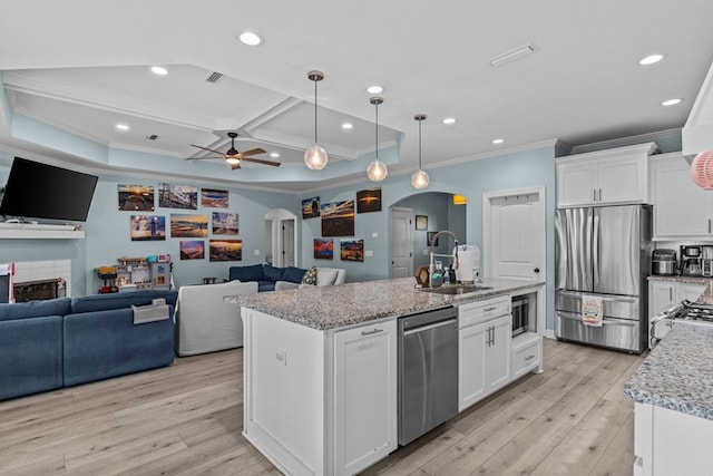 213 Archer Trl, Enterprise, AL 36351 - kitchen featuring a sink, arched walkways, stainless steel appliances, open floor plan, and ornamental molding