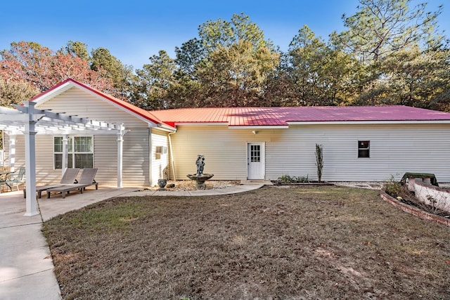 back of house with a patio, a lawn, and a pergola