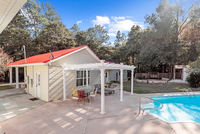 view of swimming pool featuring a patio, an outdoor structure, and a pergola