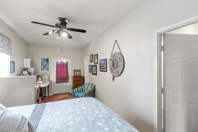 bedroom with ceiling fan and a textured ceiling