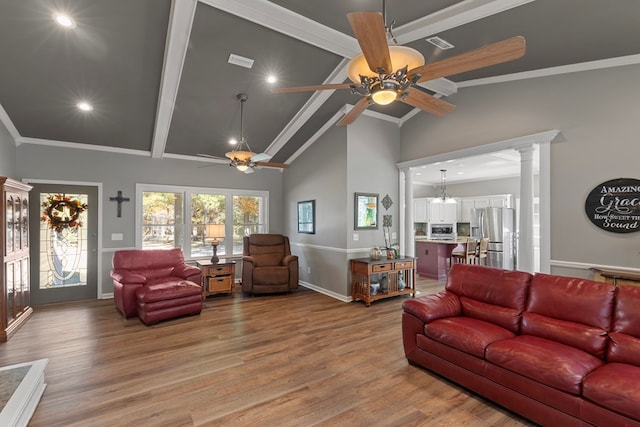 living room featuring hardwood / wood-style floors, ornamental molding, ceiling fan, and ornate columns