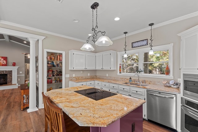 kitchen with sink, white cabinetry, a center island, appliances with stainless steel finishes, and dark hardwood / wood-style flooring