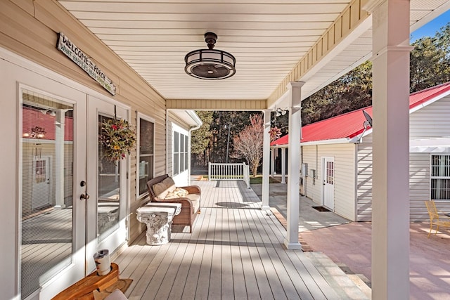 wooden terrace featuring an outdoor structure