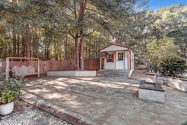 view of patio / terrace with an outbuilding