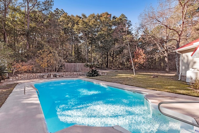 view of swimming pool with a yard and a patio