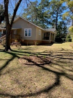 view of property exterior with a lawn