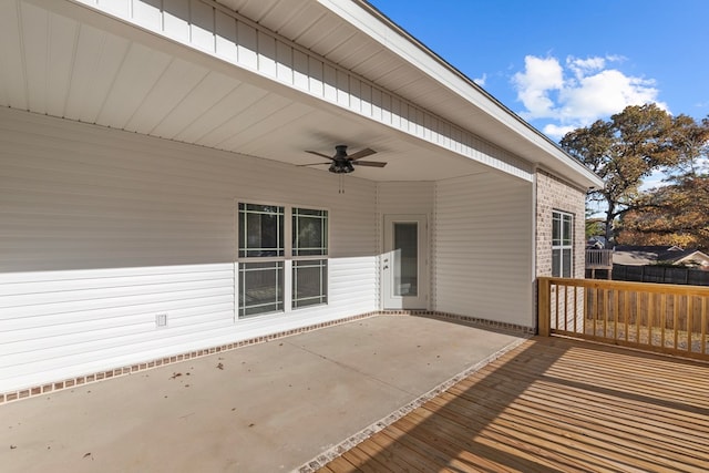 wooden deck featuring ceiling fan and a patio