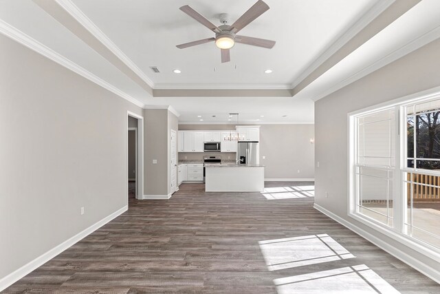 unfurnished living room featuring hardwood / wood-style floors, ceiling fan, and ornamental molding