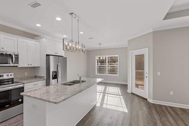 kitchen with appliances with stainless steel finishes, dark hardwood / wood-style flooring, a kitchen island with sink, white cabinets, and hanging light fixtures