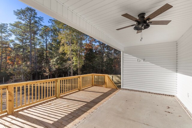 wooden terrace with ceiling fan and a patio