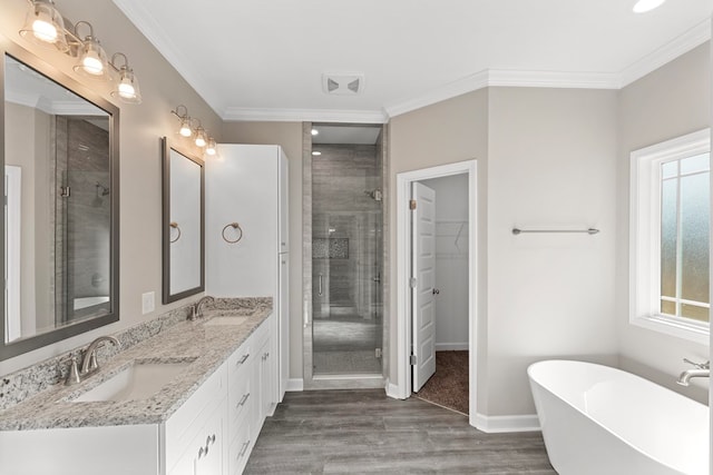 bathroom with crown molding, plenty of natural light, plus walk in shower, and hardwood / wood-style flooring