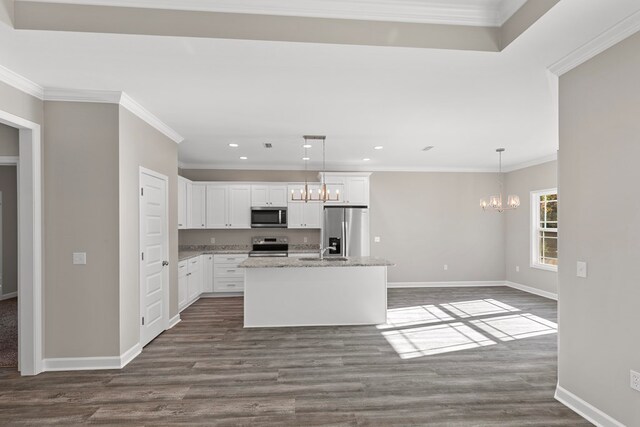 kitchen featuring a center island with sink, crown molding, dark hardwood / wood-style floors, white cabinetry, and stainless steel appliances