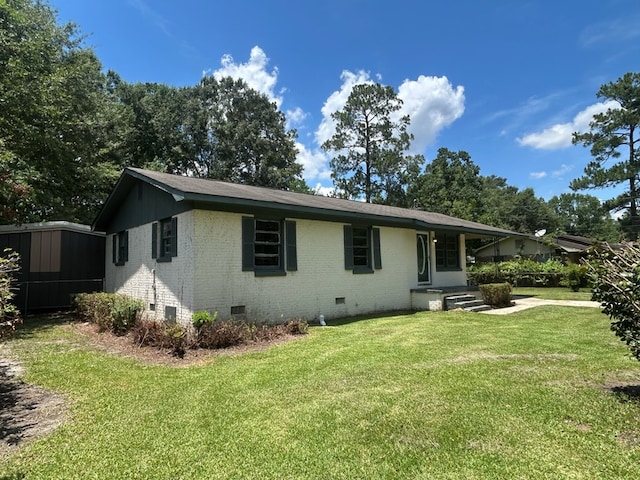 402 Reid Dr, Dothan, AL 36301 - rear view of house featuring crawl space, brick siding, and a yard