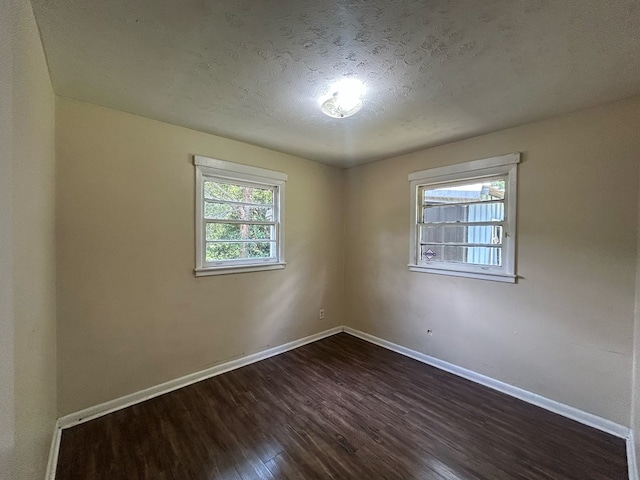 402 Reid Dr, Dothan, AL 36301 - unfurnished room featuring dark wood-type flooring and a textured ceiling