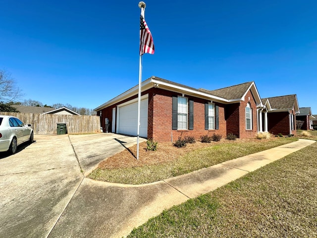 view of property exterior with a garage, concrete driveway, brick siding, and fence