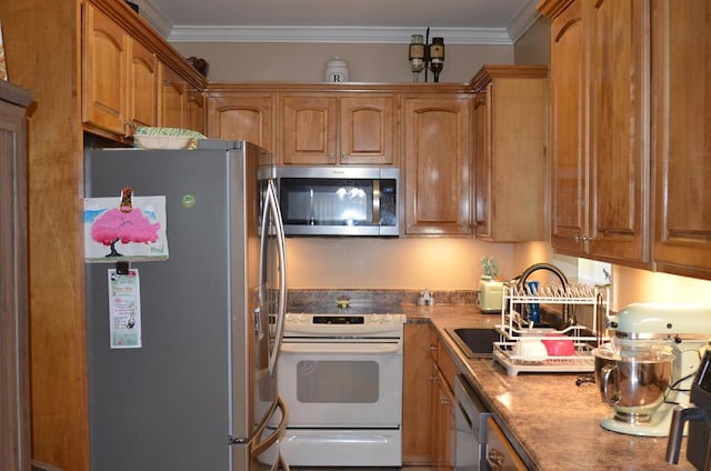124 Whitney Ave, Enterprise, AL 36330 - kitchen featuring appliances with stainless steel finishes, ornamental molding, and brown cabinets