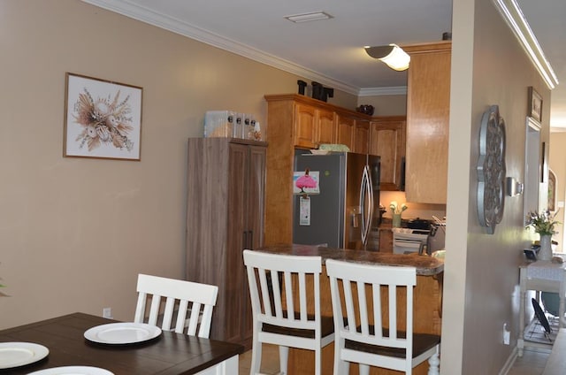 124 Whitney Ave, Enterprise, AL 36330 - kitchen with stainless steel refrigerator with ice dispenser, crown molding, and brown cabinets