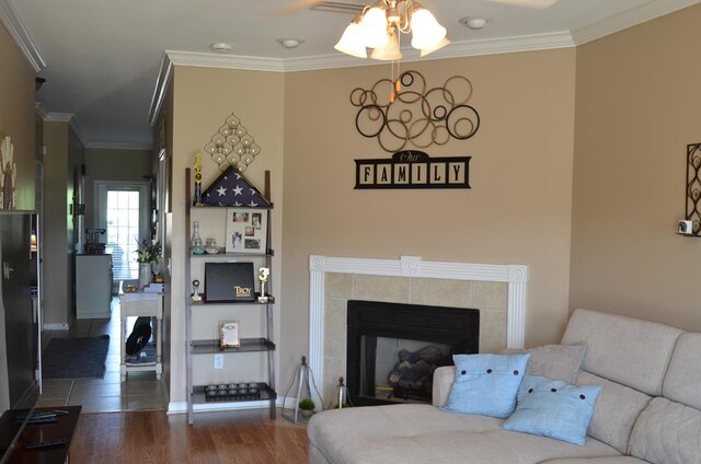 124 Whitney Ave, Enterprise, AL 36330 - living area with a ceiling fan, wood finished floors, ornamental molding, and a tile fireplace