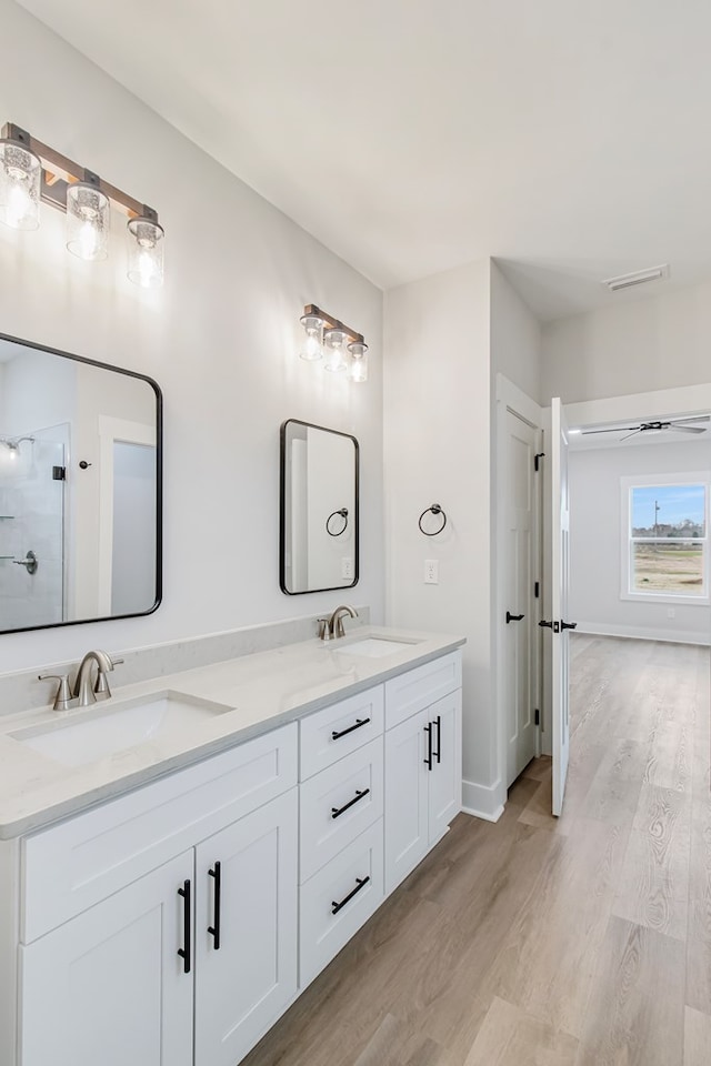 1919 Silcox Rd, Ashford, AL 36312 - full bath with baseboards, double vanity, a sink, and wood finished floors