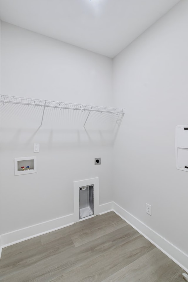 1919 Silcox Rd, Ashford, AL 36312 - laundry area featuring hookup for a washing machine, baseboards, light wood-style floors, electric dryer hookup, and laundry area