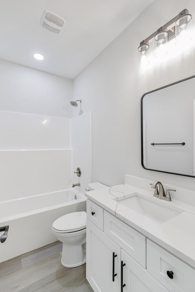1919 Silcox Rd, Ashford, AL 36312 - full bath featuring toilet, vanity, wood finished floors, tub / shower combination, and visible vents