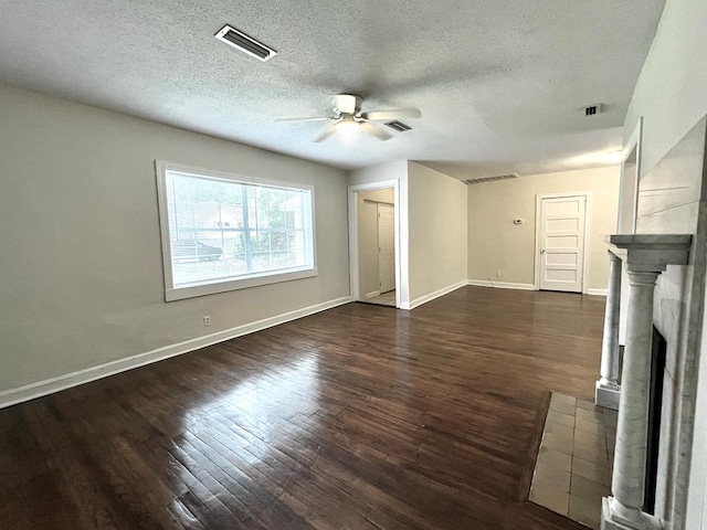 115 Westmont Dr, Dothan, AL 36301 - unfurnished living room with a ceiling fan, dark wood-style flooring, a textured ceiling, and a fireplace with flush hearth