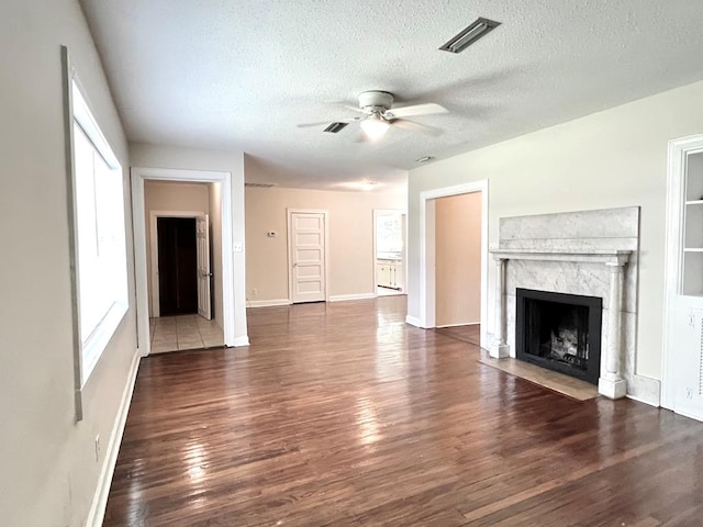 115 Westmont Dr, Dothan, AL 36301 - unfurnished living room with a ceiling fan, healthy amount of natural light, wood finished floors, and a textured ceiling