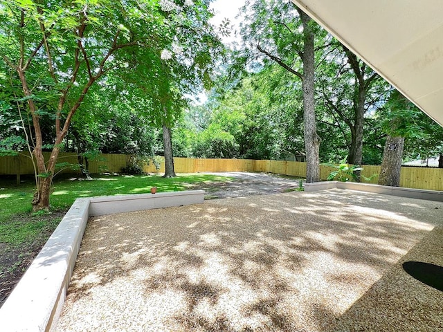 115 Westmont Dr, Dothan, AL 36301 - fenced backyard with a patio and view of wooded area