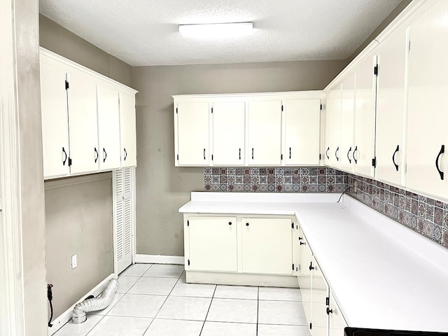 115 Westmont Dr, Dothan, AL 36301 - laundry area featuring light tile patterned flooring and a textured ceiling