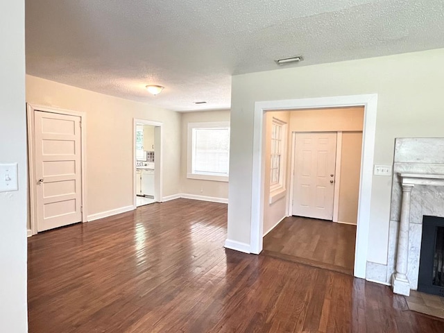 115 Westmont Dr, Dothan, AL 36301 - unfurnished living room featuring dark wood-style flooring, a textured ceiling, and a fireplace