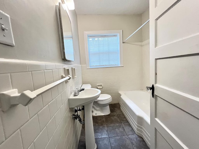 115 Westmont Dr, Dothan, AL 36301 - full bathroom with tile patterned floors, bathing tub / shower combination, tile walls, and a wainscoted wall